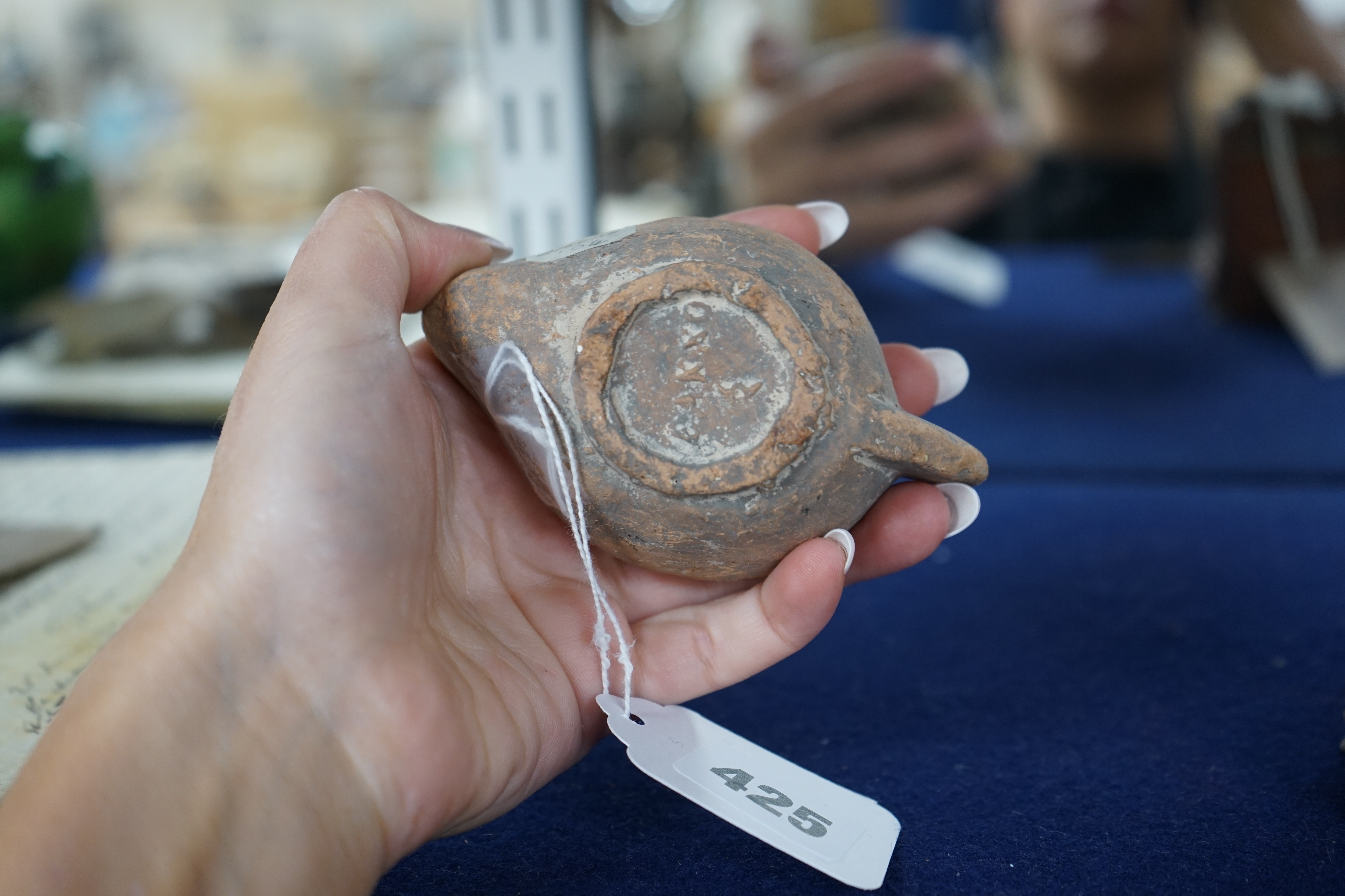 An Ancient Greek 'Athens' terracotta oil lamp, 10cm. Condition - fair